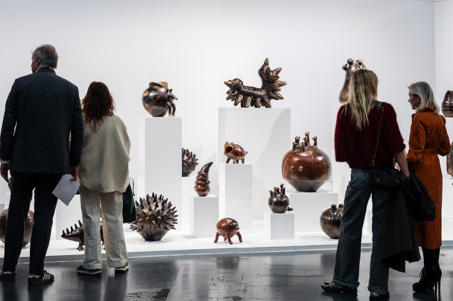 Visitors viewing ceramic sculptures
